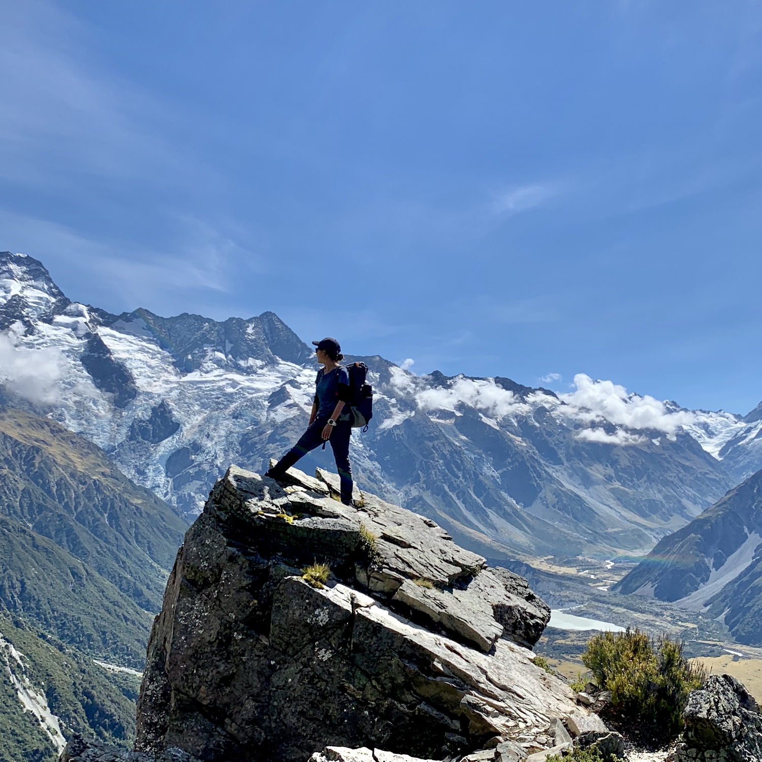 登山者が遠くにある山脈を眺めている。