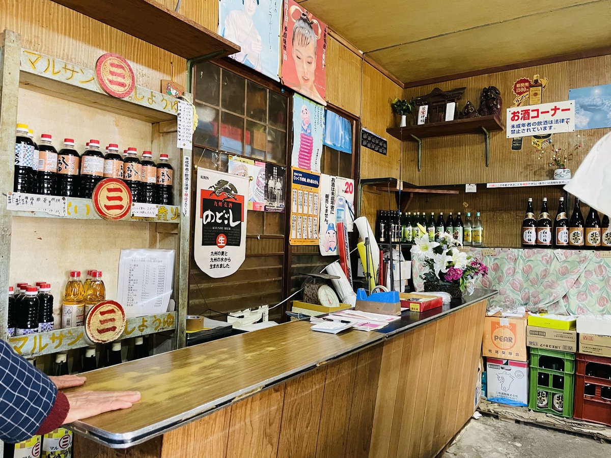 酒屋の棚にお酒、醤油が並んでいる様子