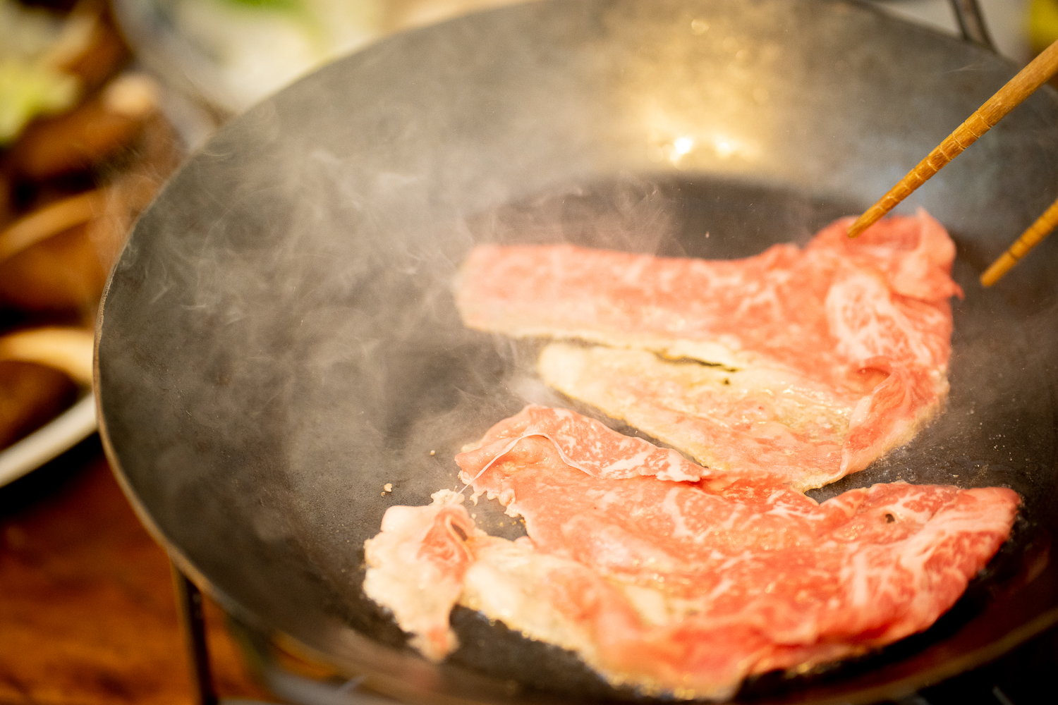 フライパンで肉を焼く様子