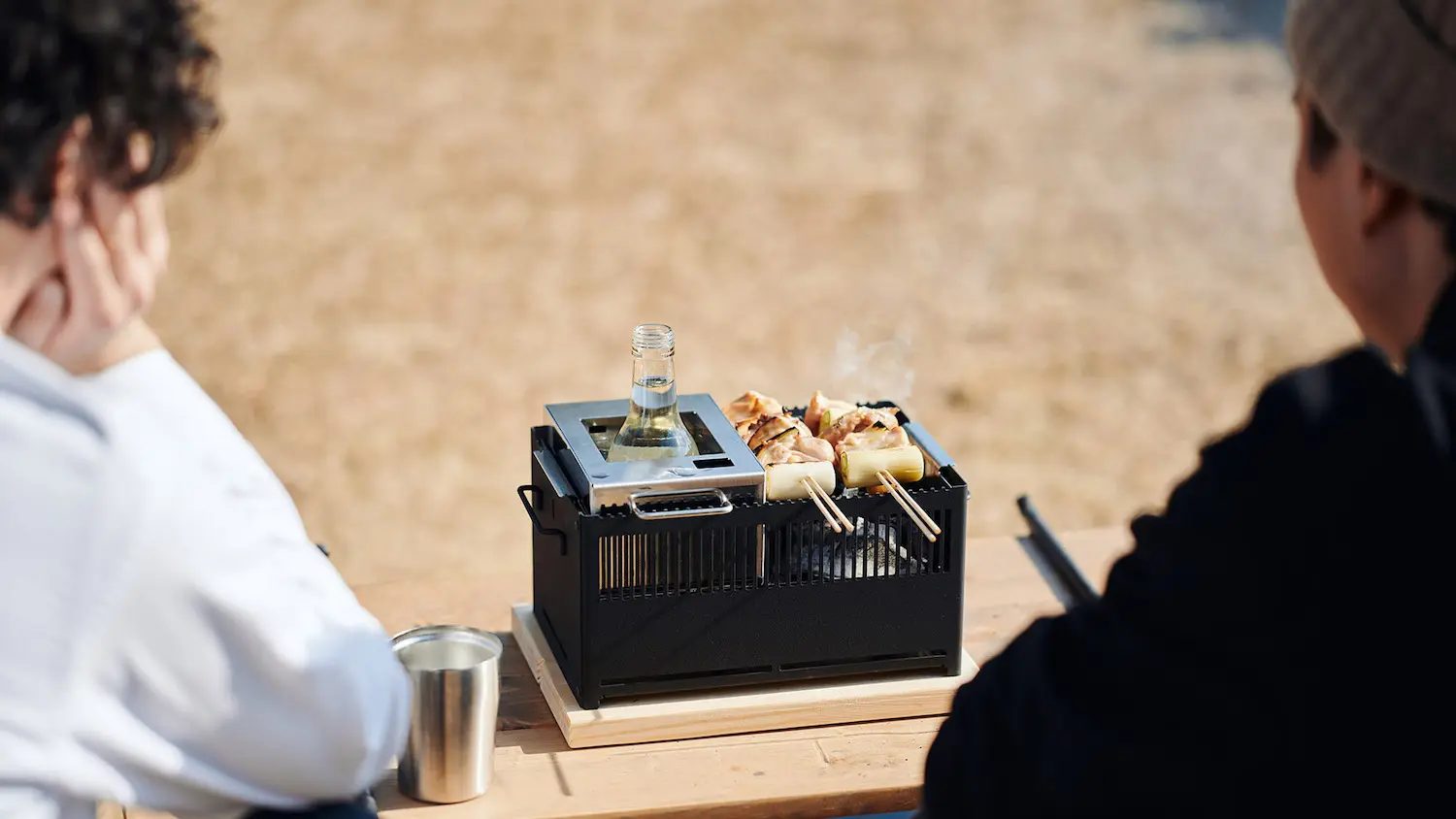 屋外で熱燗、焼き鳥を楽しむ様子