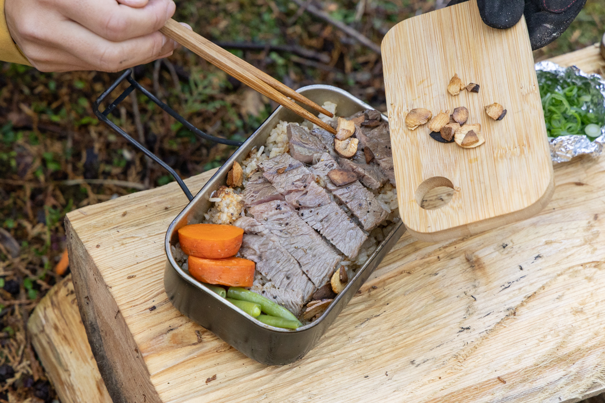 肉、野菜、にんにくを米の上に載せる