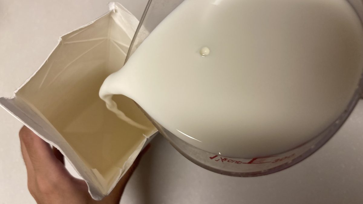 牛乳パックに牛乳を入れてる様子